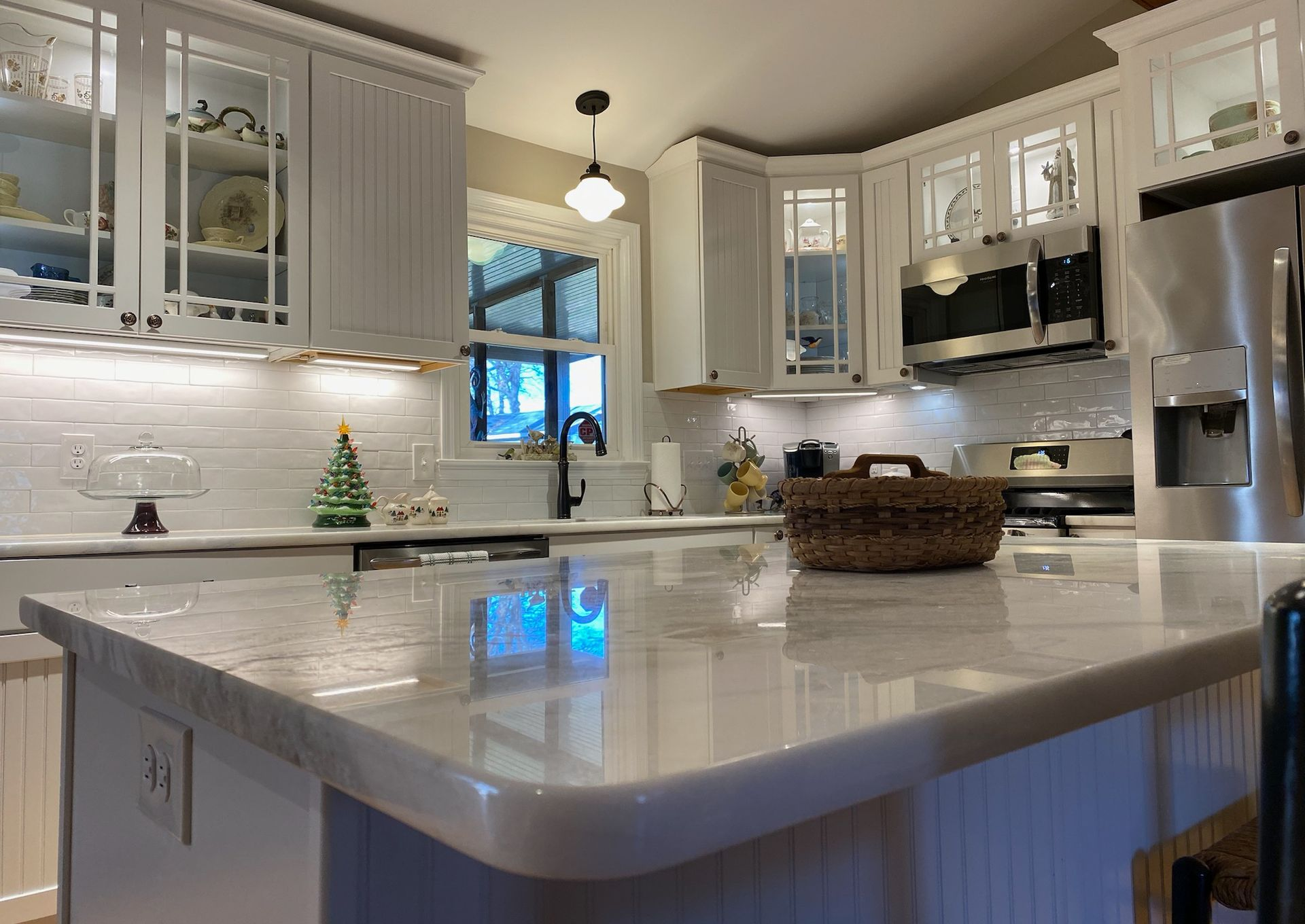 A kitchen with a large island and stainless steel appliances.