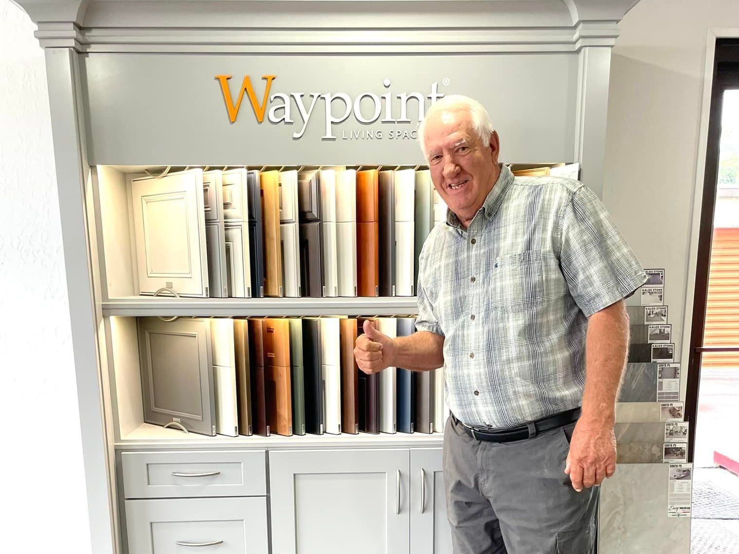A man is standing in front of a waypoint cabinet display.