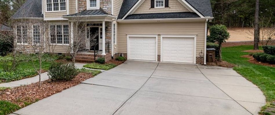 Front view of a home with decorative concrete driveway crafted by local concrete driveway contractors