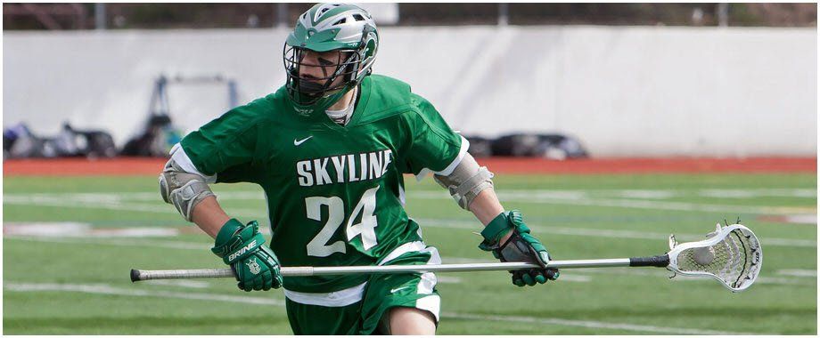 A lacrosse player is holding a stick on a field.