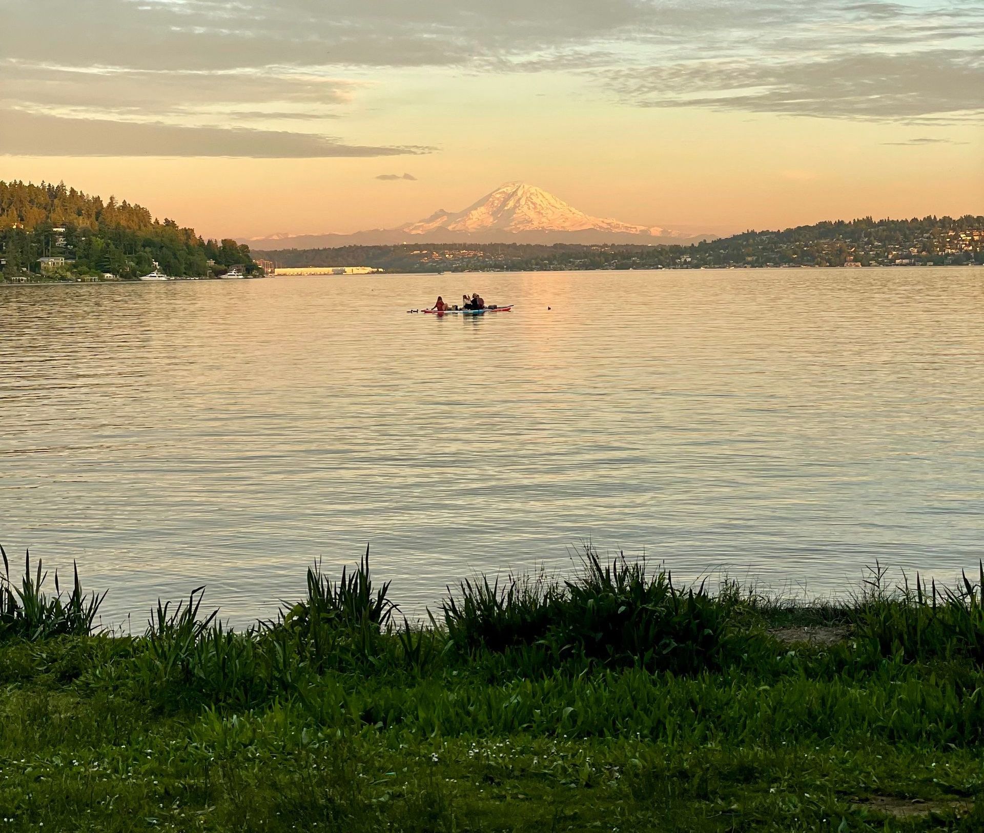 A lake with a mountain in the background and a boat in the water