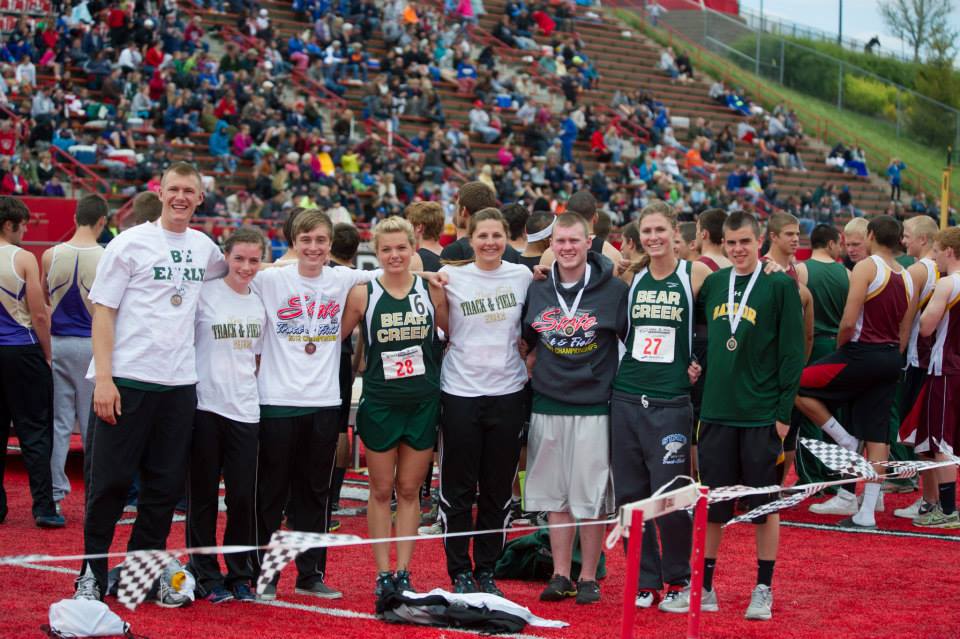 A group of people posing for a picture on a track