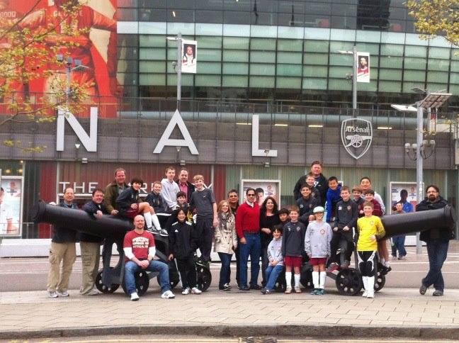 A group of people standing in front of a building that says nal