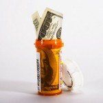 A bottle of pills with a dollar bill sticking out of it.
