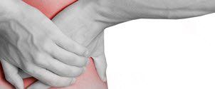 A person is holding their stomach in pain.