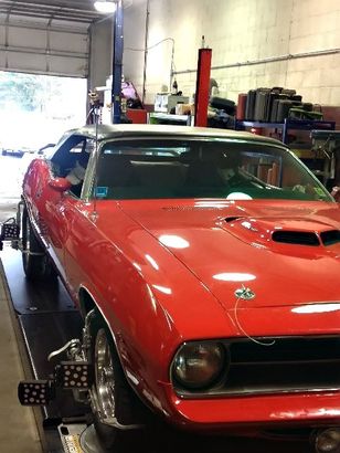 red car in garage  — automotive repair in Somerdale, NJ