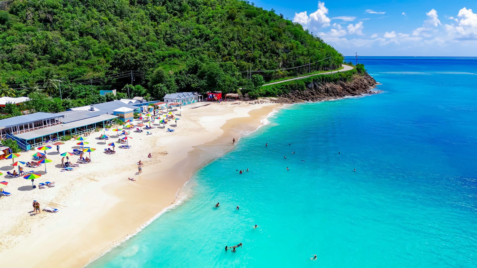 An aerial view of Dark wood beach with a lot of people on it.