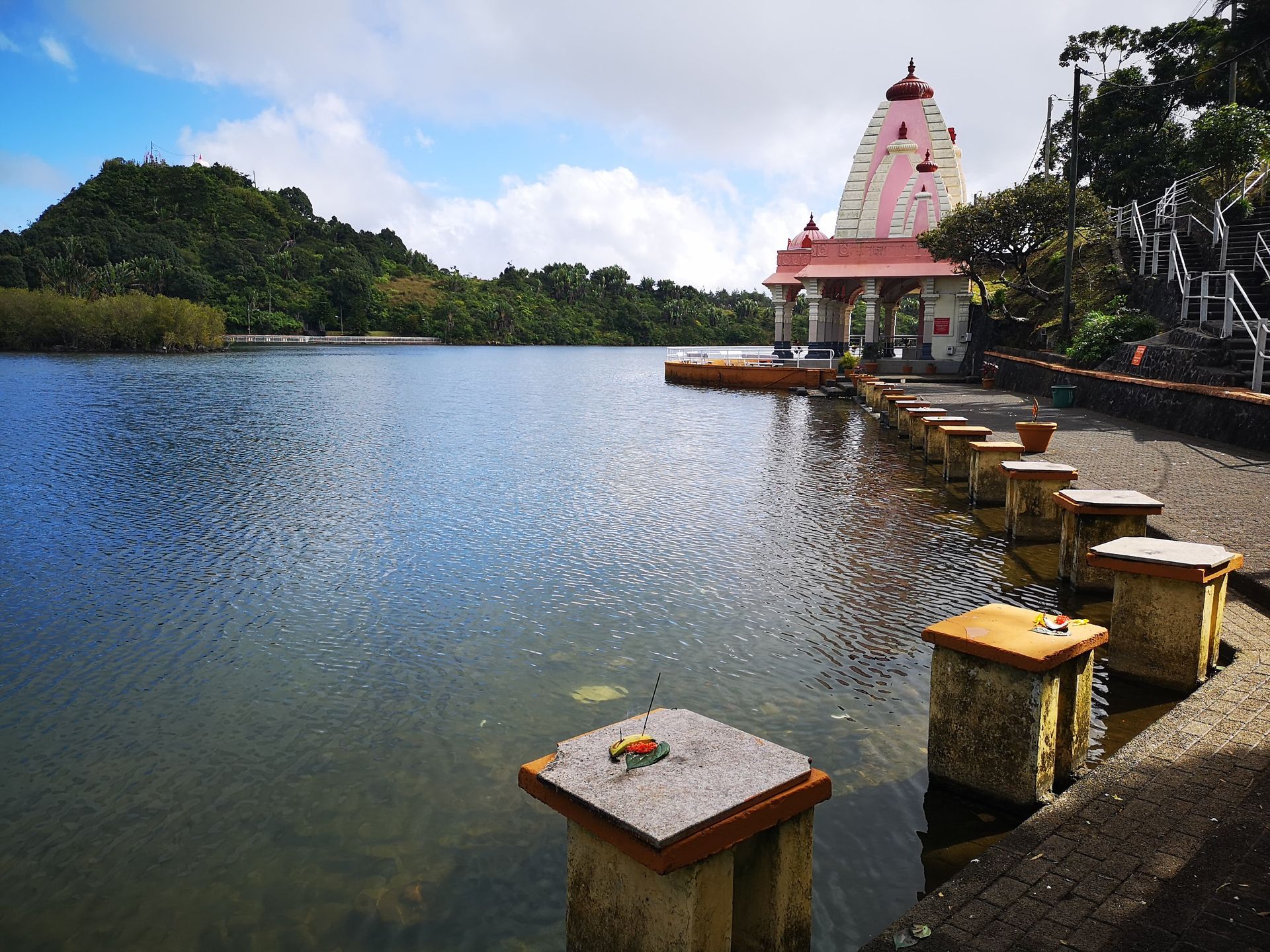 A temple sits on the shore of a lake in Grand Bassin