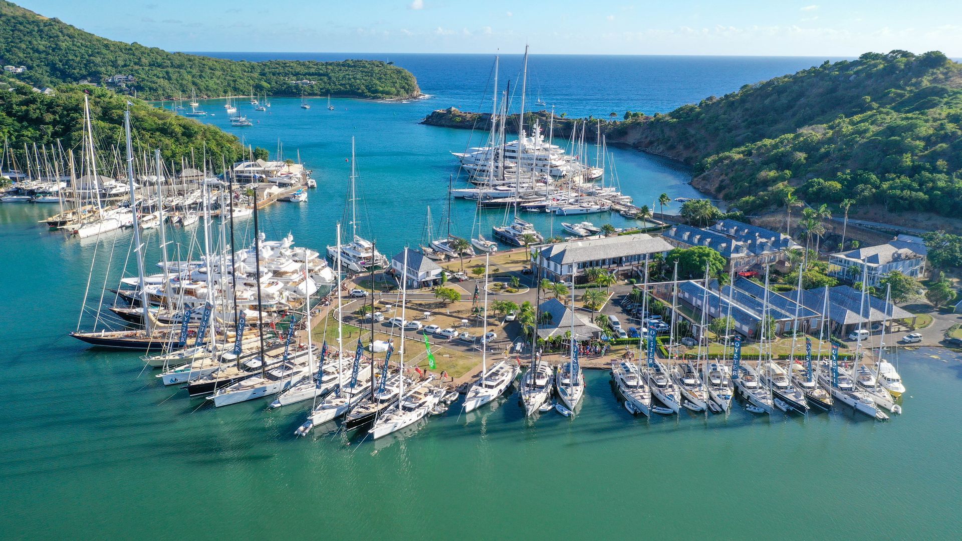 An aerial view of a marina with boats docked in the water at English Harbour in Antigua