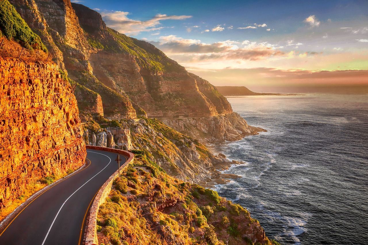 An aerial view of Garden route road going through a cliff overlooking the ocean.
