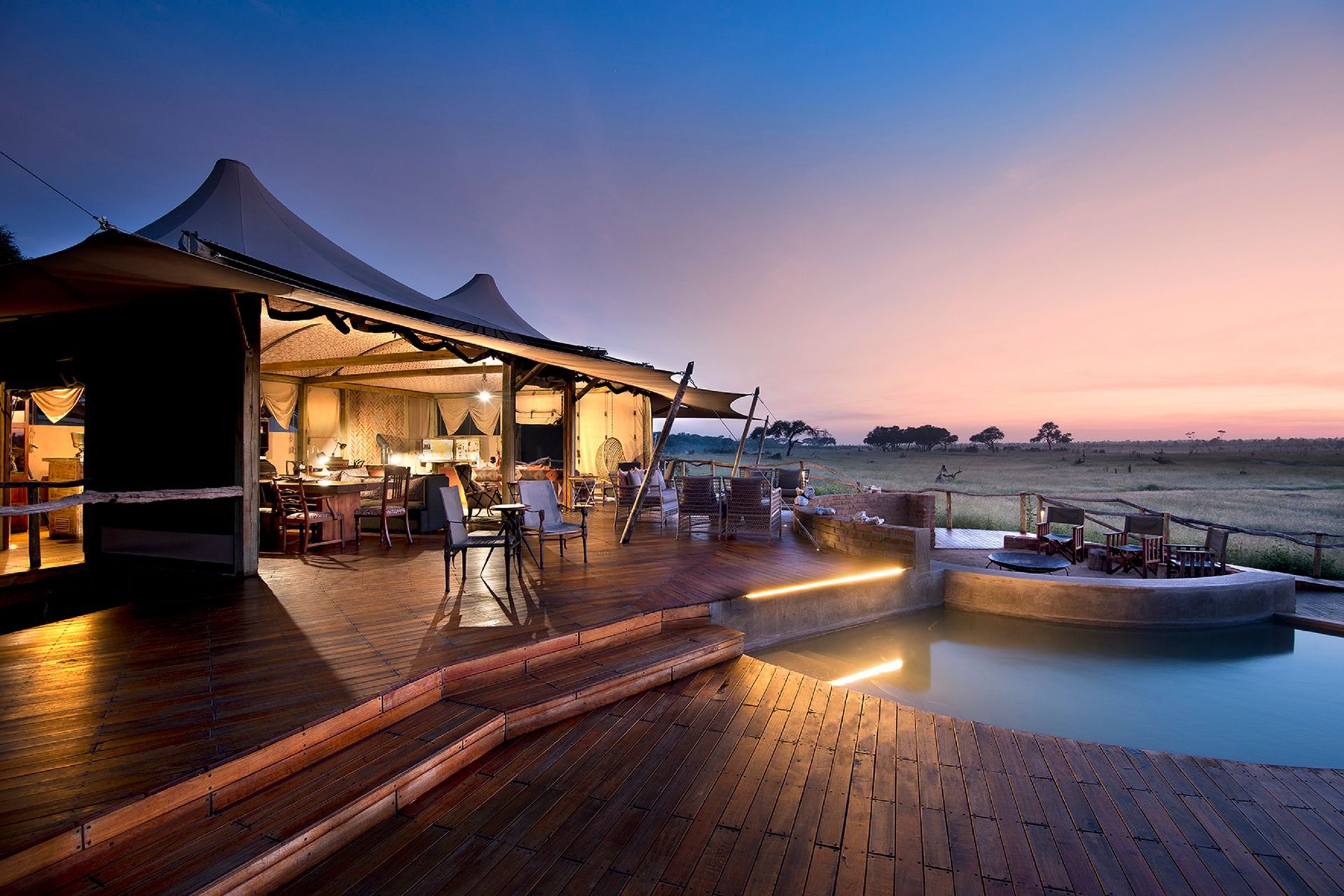 A large Safari lodge called Somalisa Tented Camp with a swimming pool in front of it