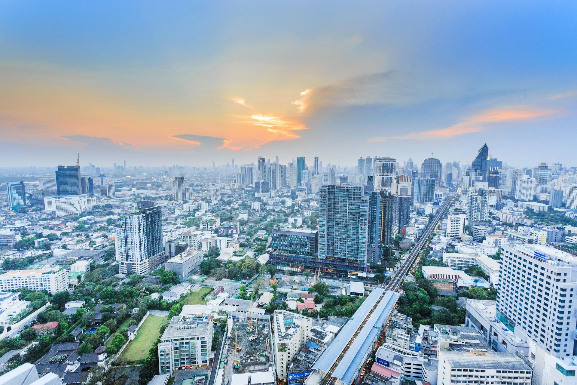 An aerial view of a city skyline at sunset.