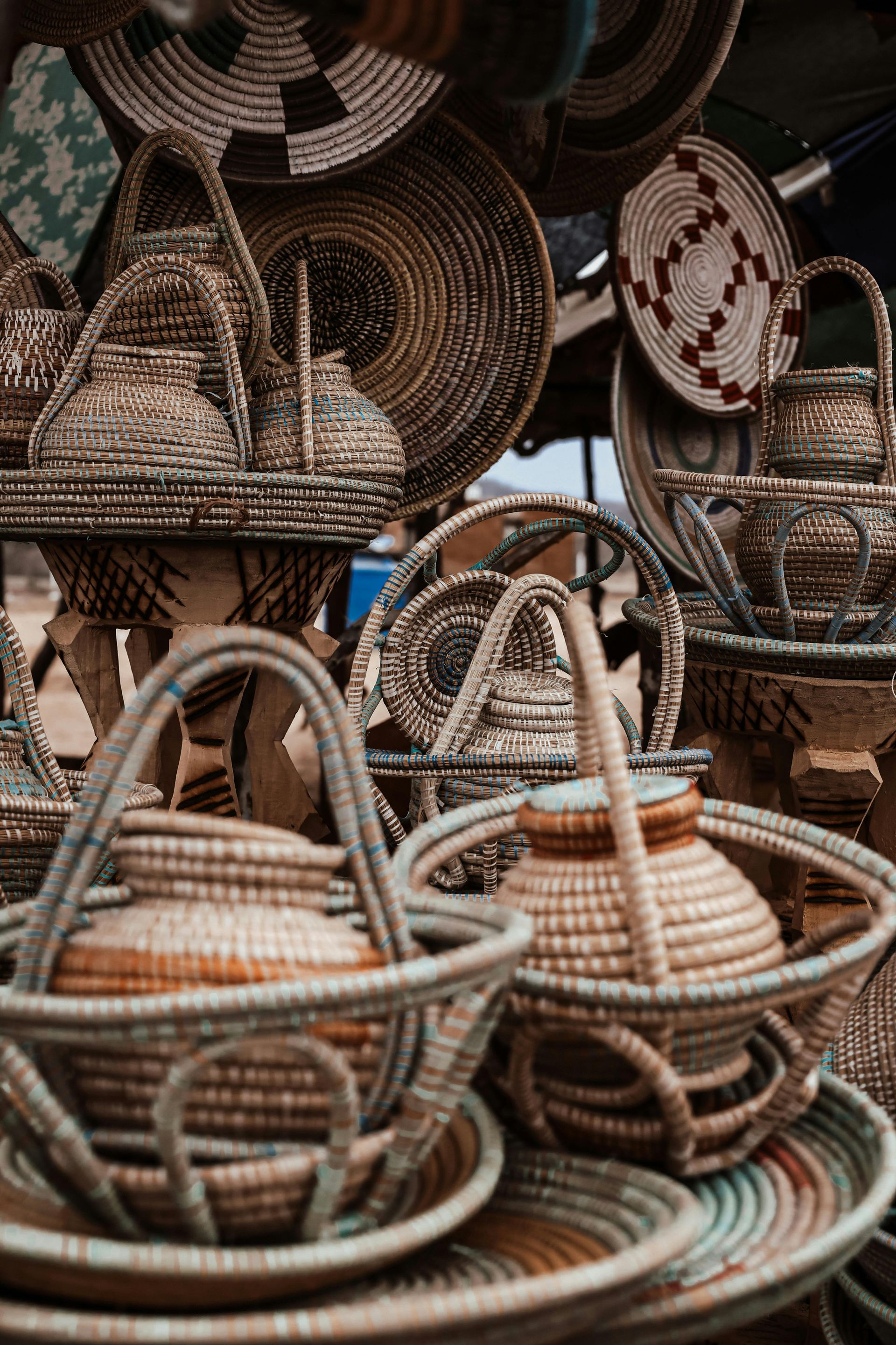 A bunch of wicker baskets are stacked on top of each other on a table.