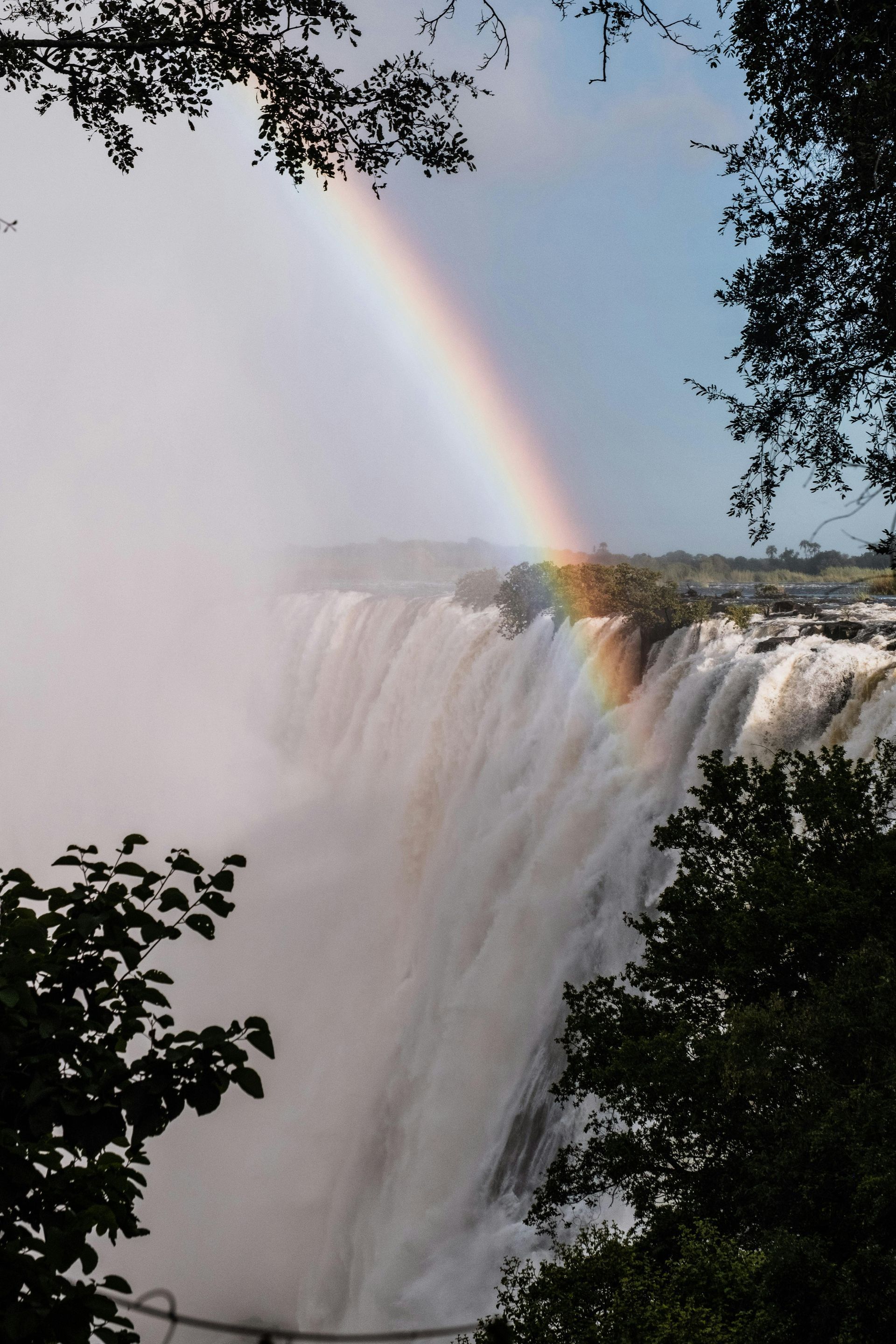 A Victoria Falls with a rainbow in the background in Zambia