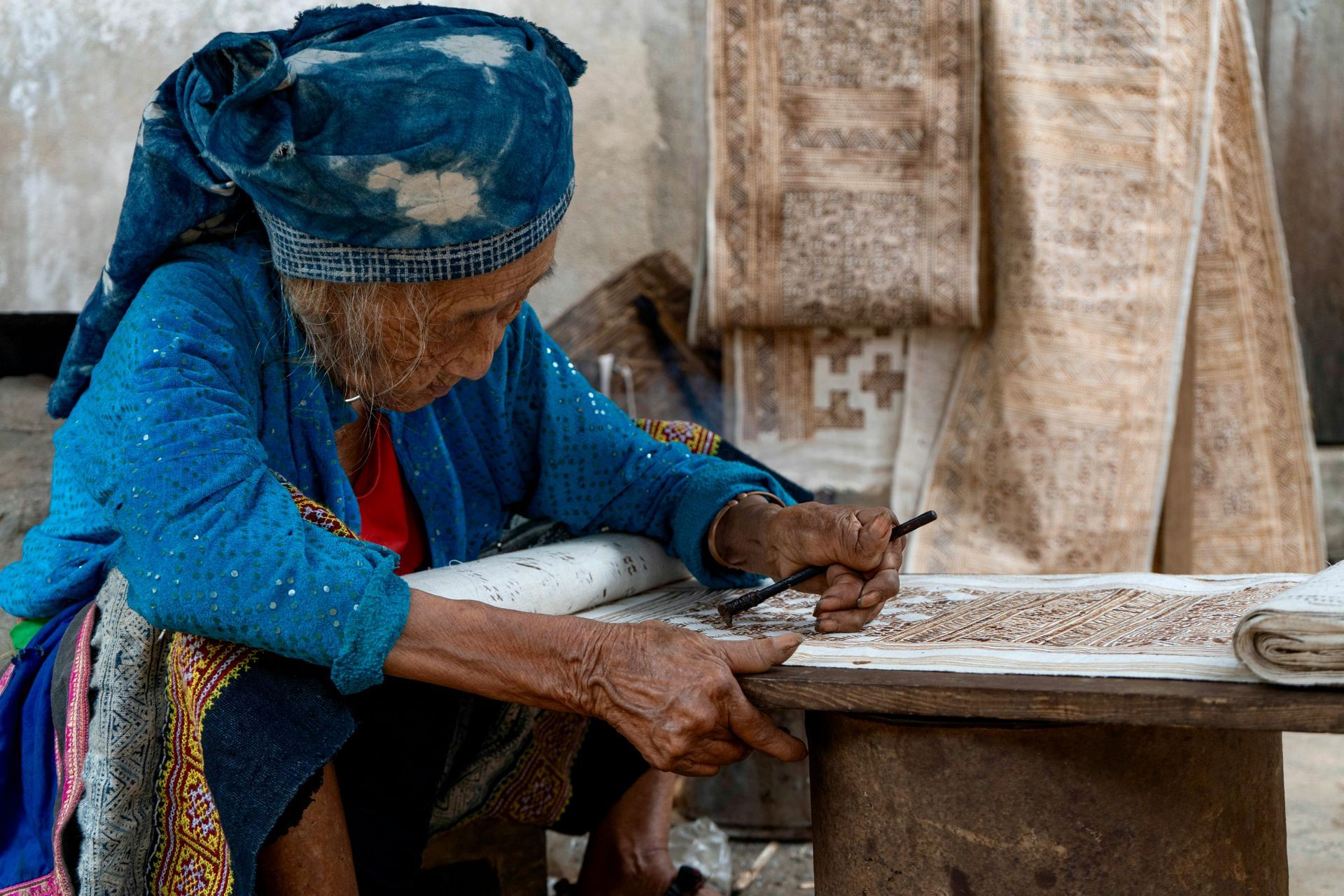 Hmong lady creating patterned cloth