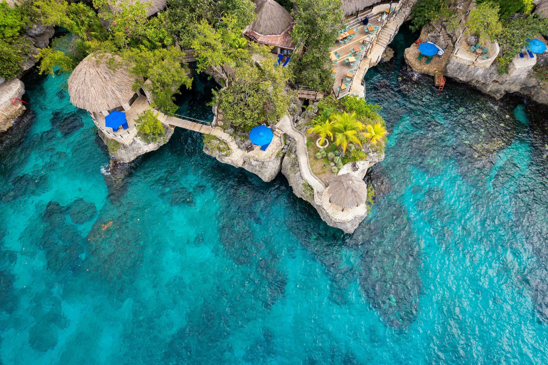 An aerial view of a cliff overlooking a body of water.