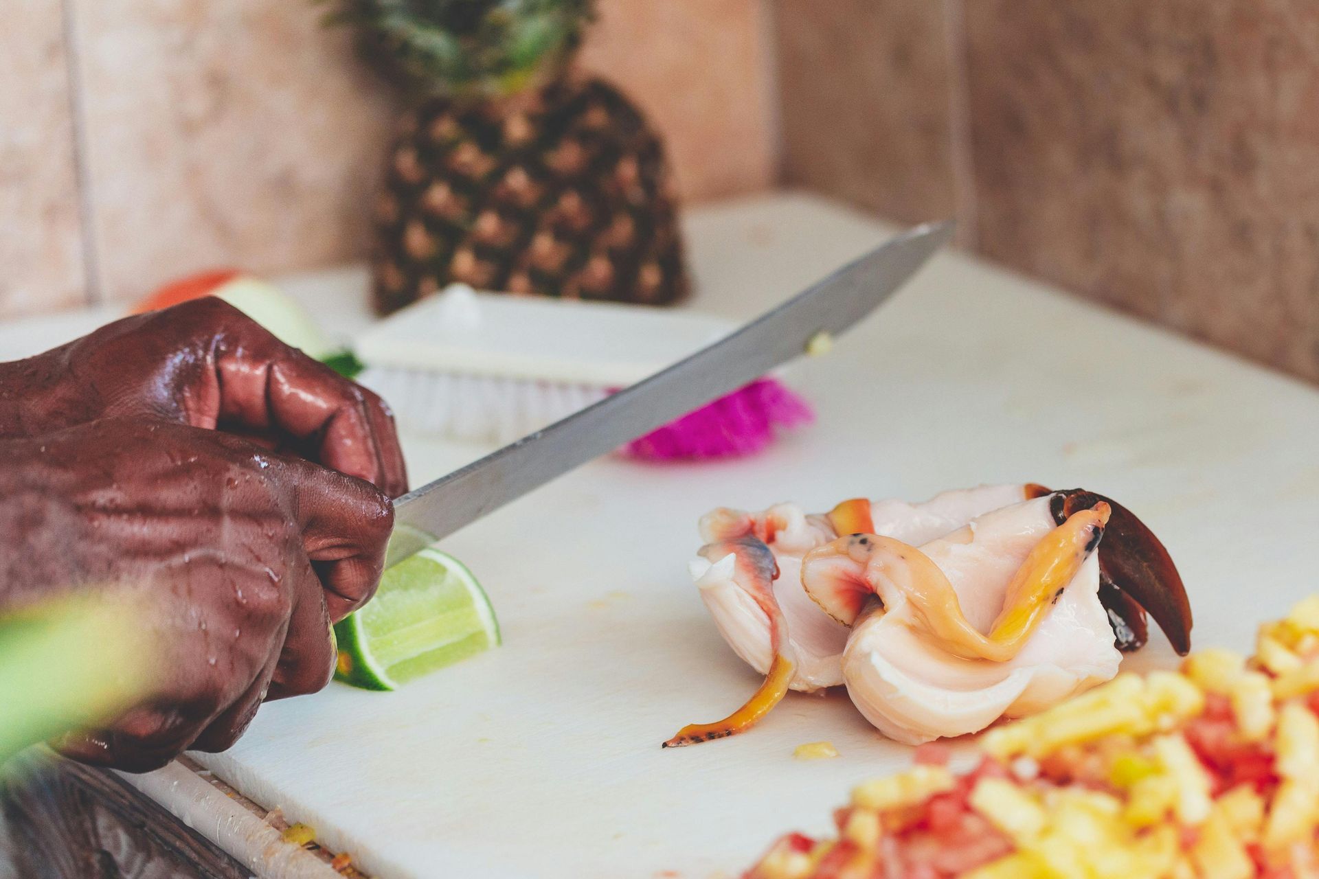 A person is cutting food on a cutting board.