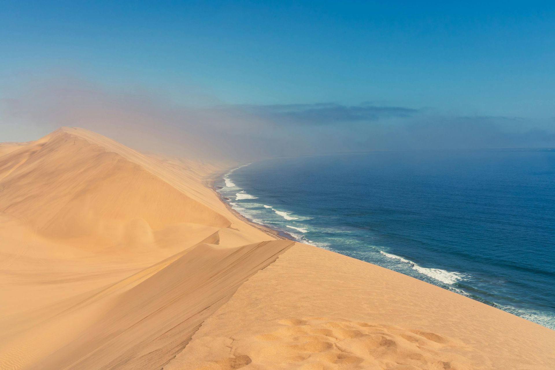 A view of a sand dune overlooking the ocean on the Skeleton Coast in Namibia