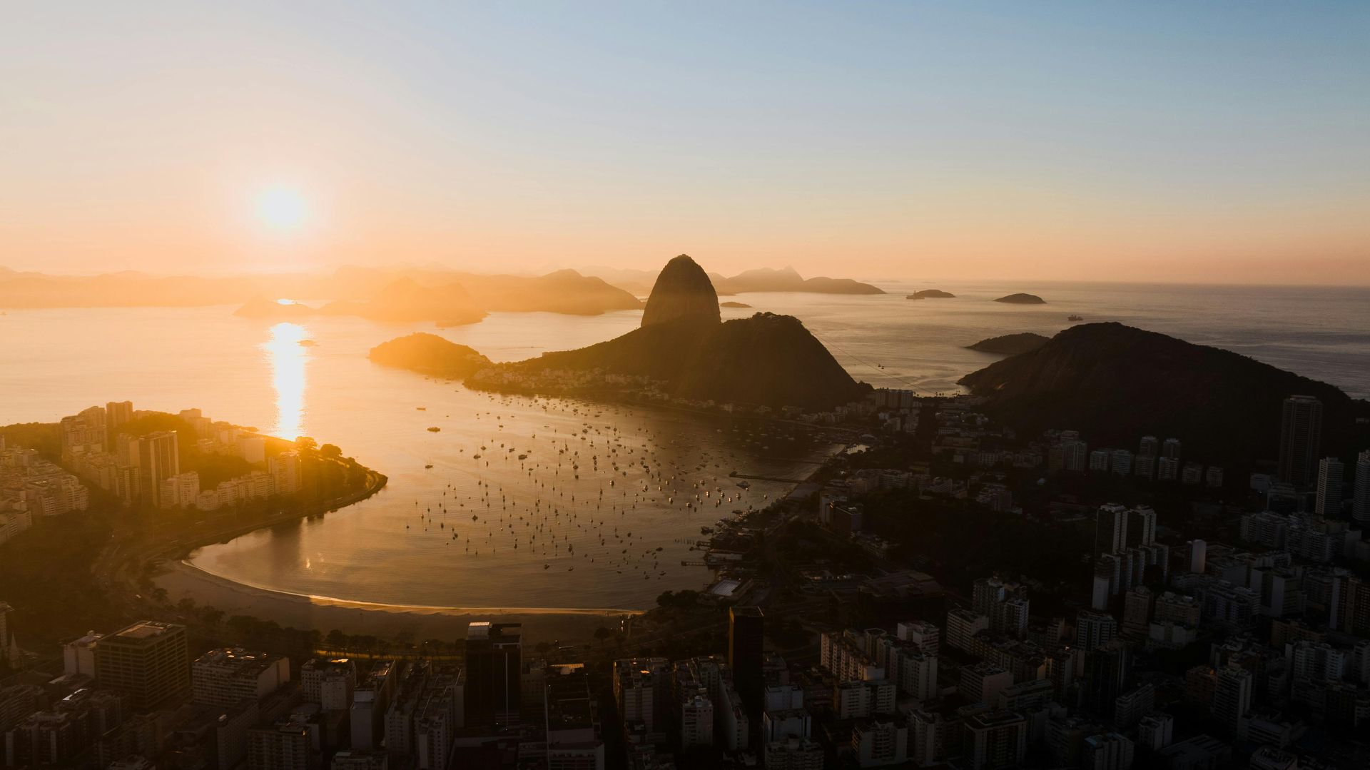 A view of a beach from a hill overlooking the ocean in Rio de Janeirio.