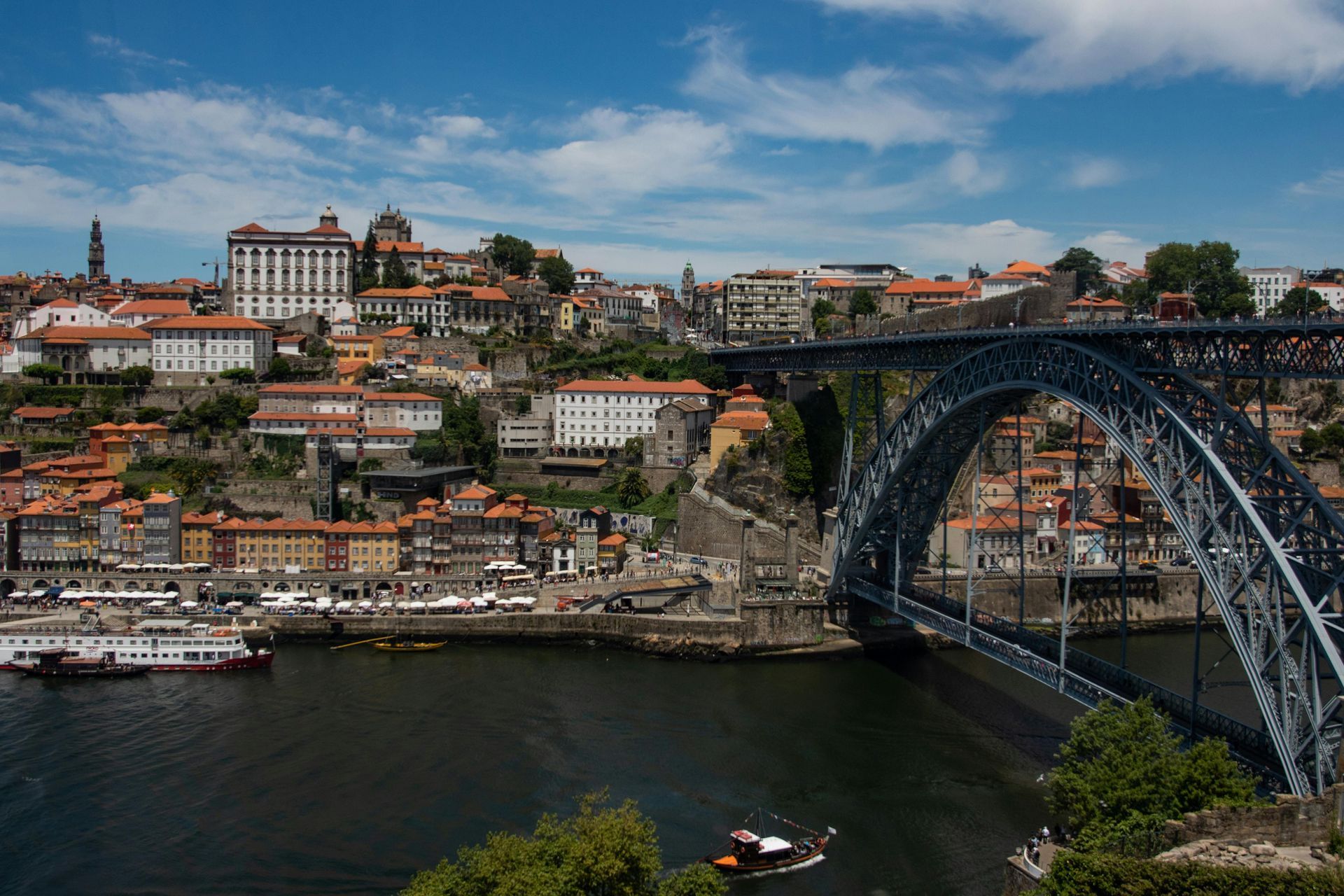 A bridge over a body of water with the city Porto in the background