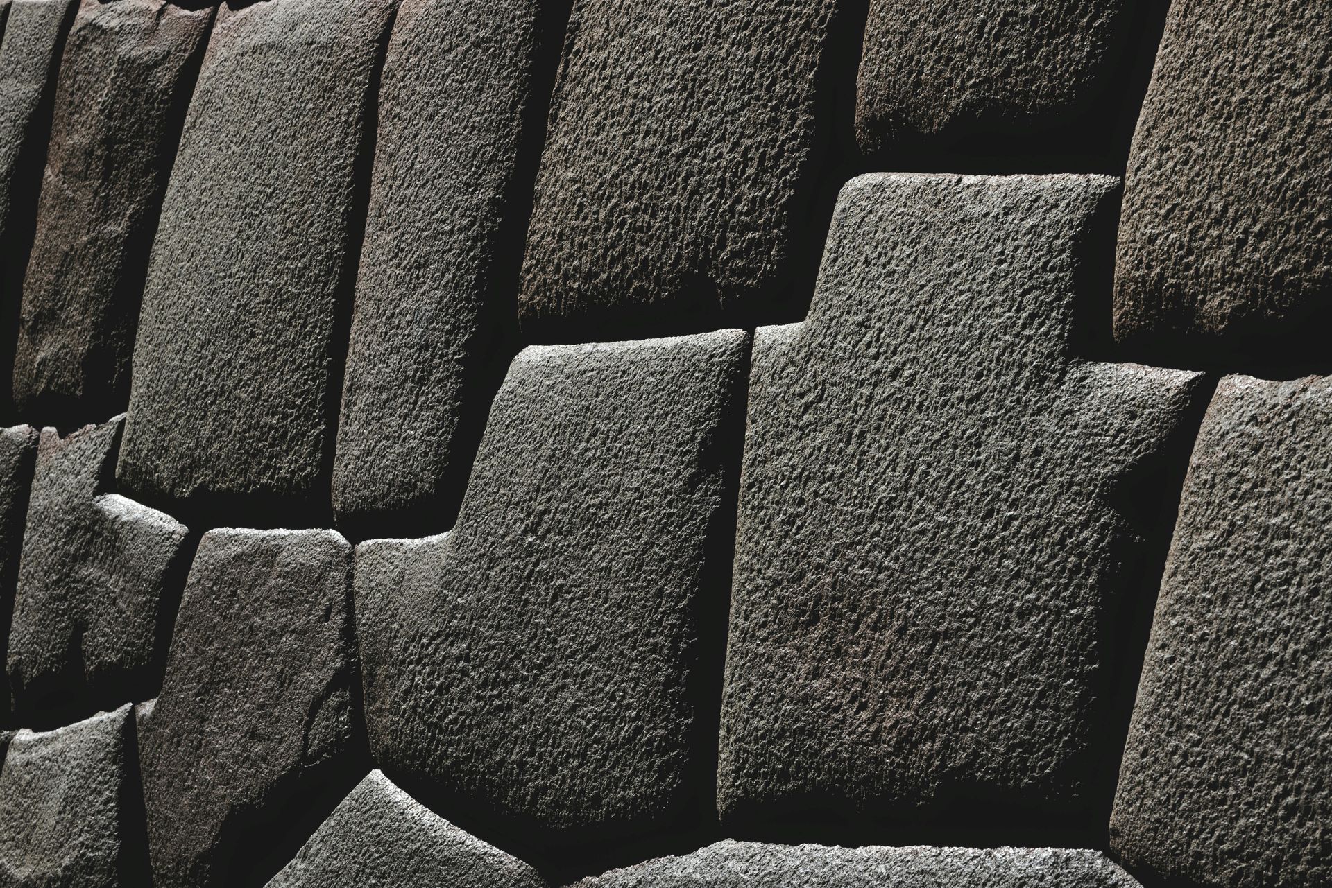 A black and white photo of a stone incan wall