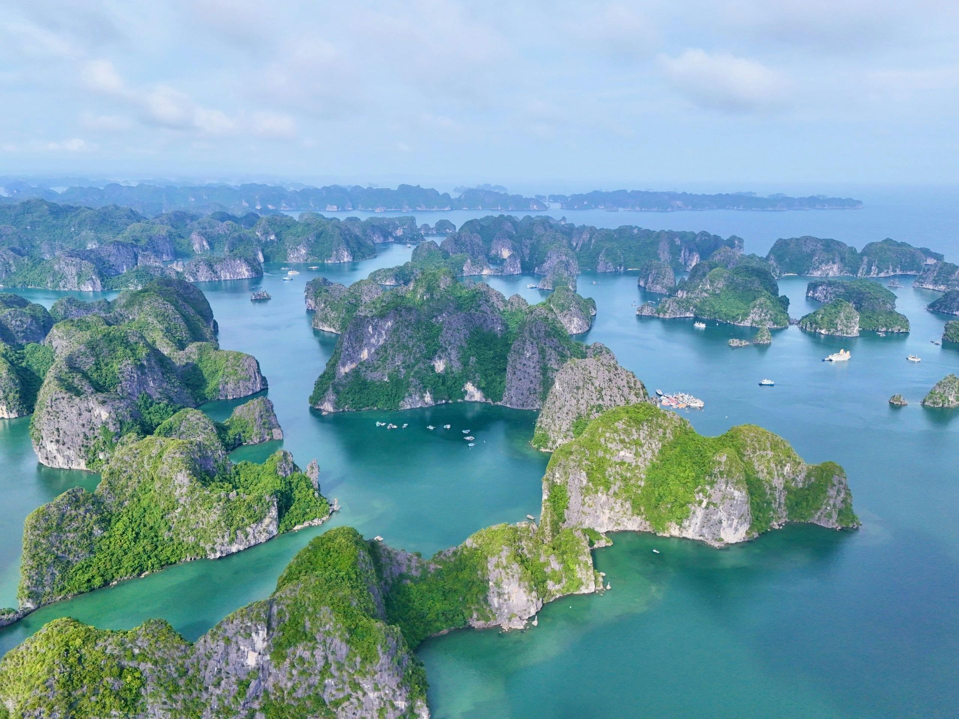 An aerial view of a large body of water surrounded by mountains and islands in Vietnam