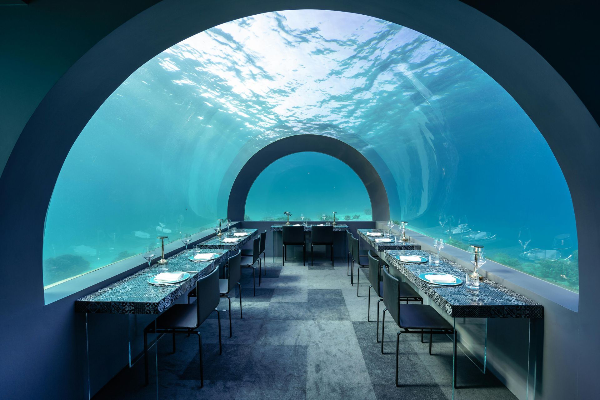 A dining room underwater with tables and chairs in Maldives
