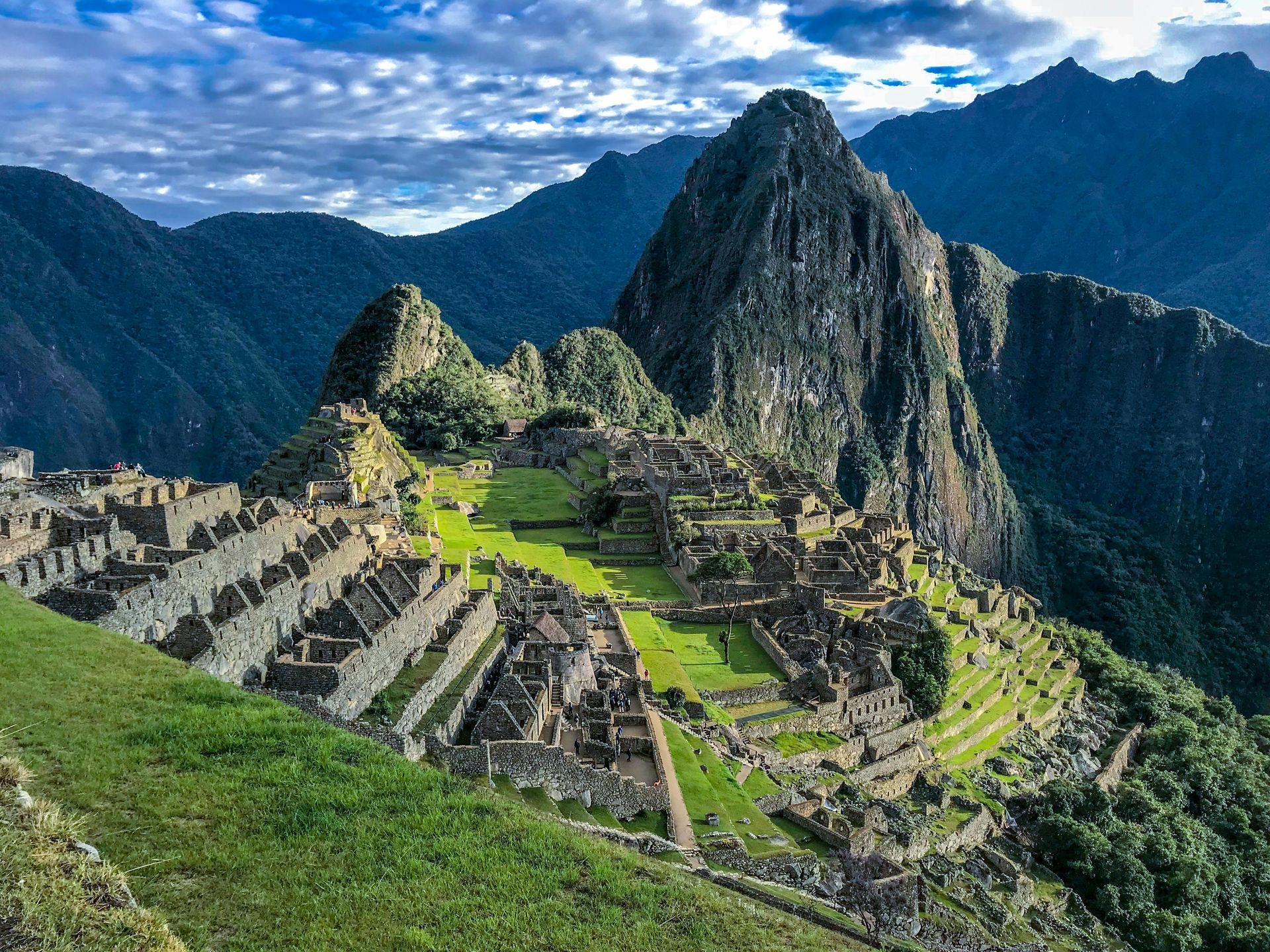 The ruins of the inca city of machu picchu are surrounded by mountains.