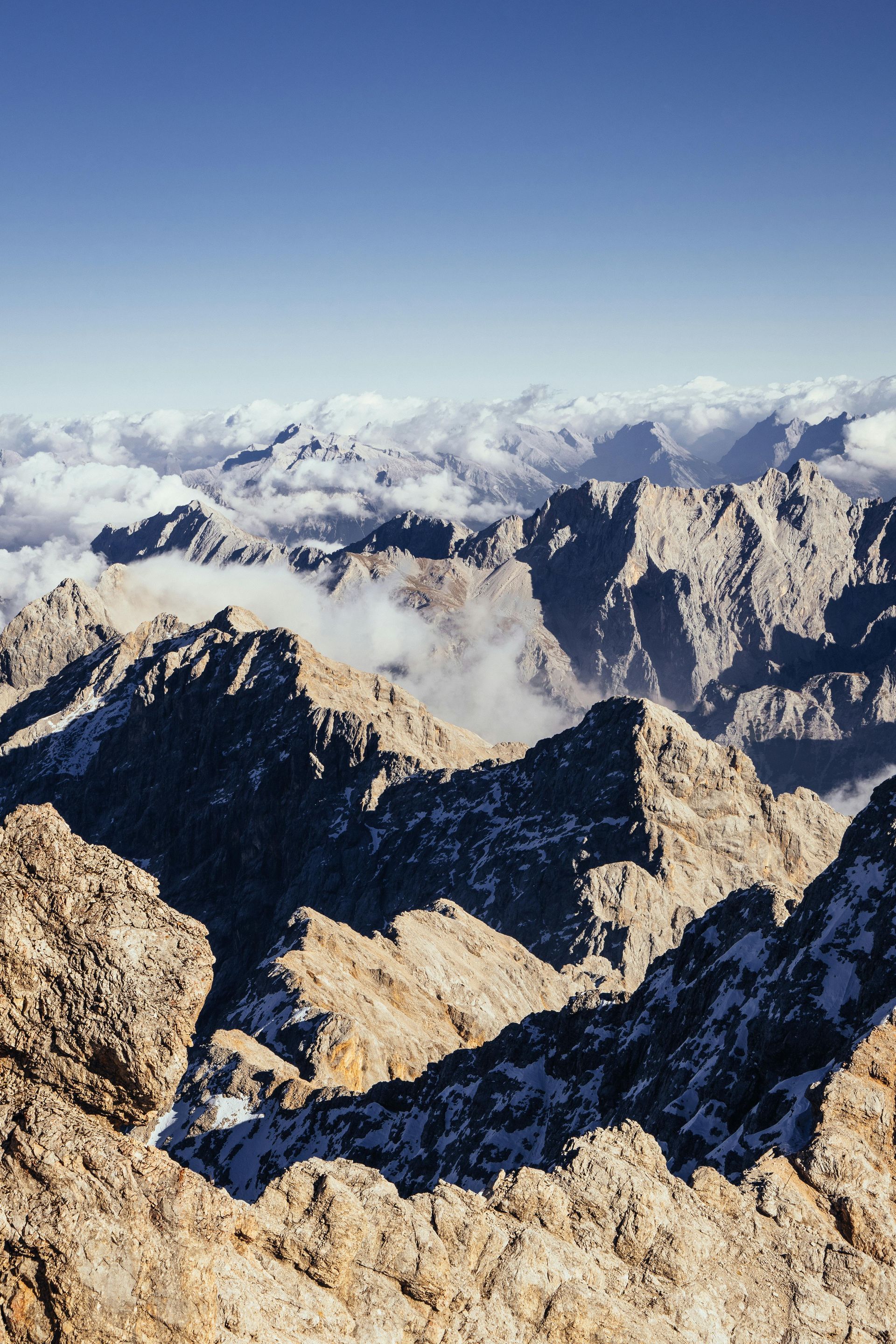 A view of a mountain range from the top of a mountain.