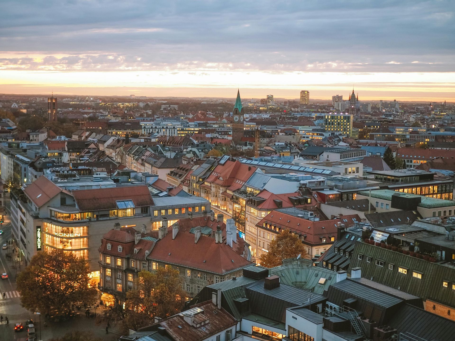 An aerial view of a city at sunset with a lot of buildings