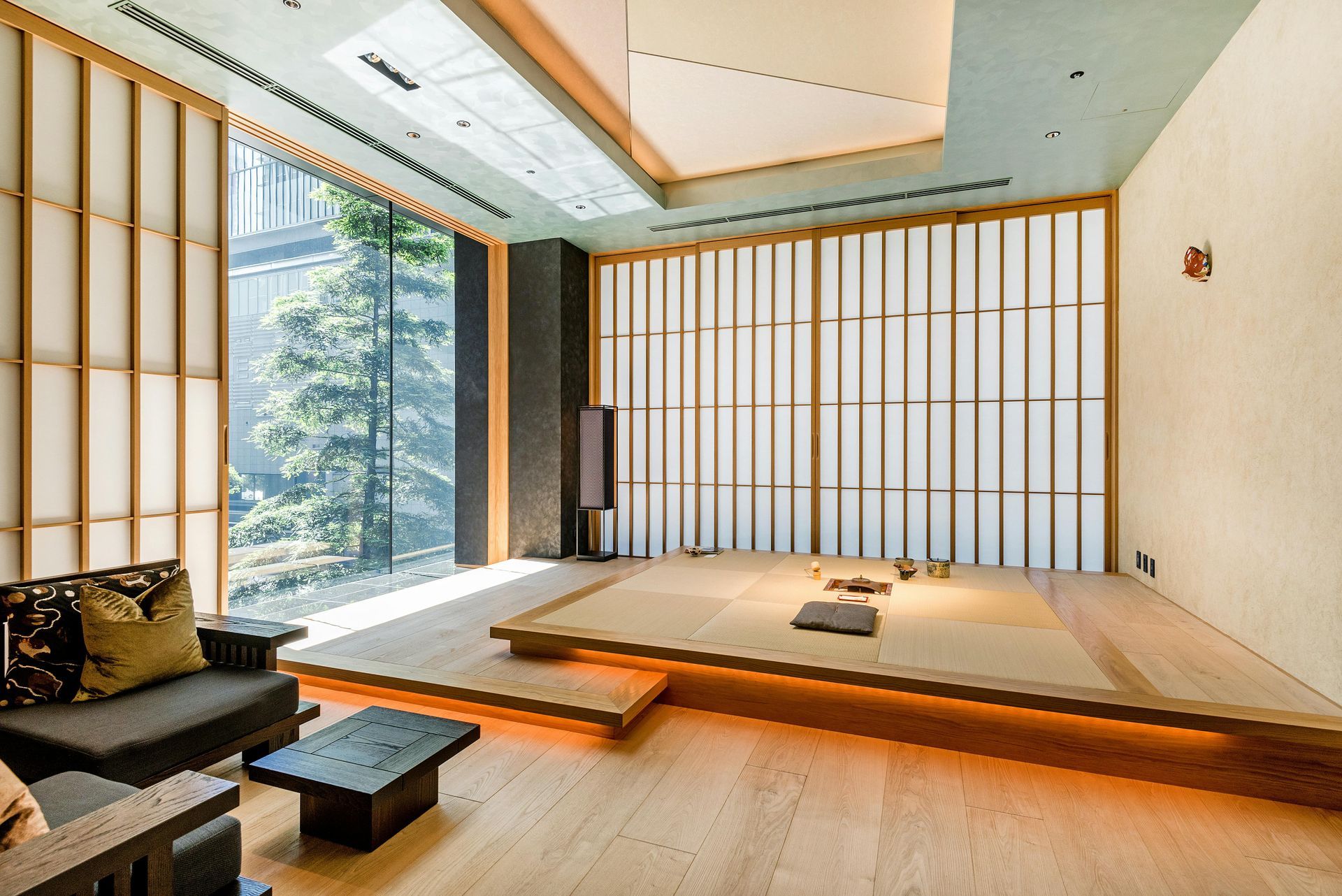 A living room with a couch and a table in it Tatami style