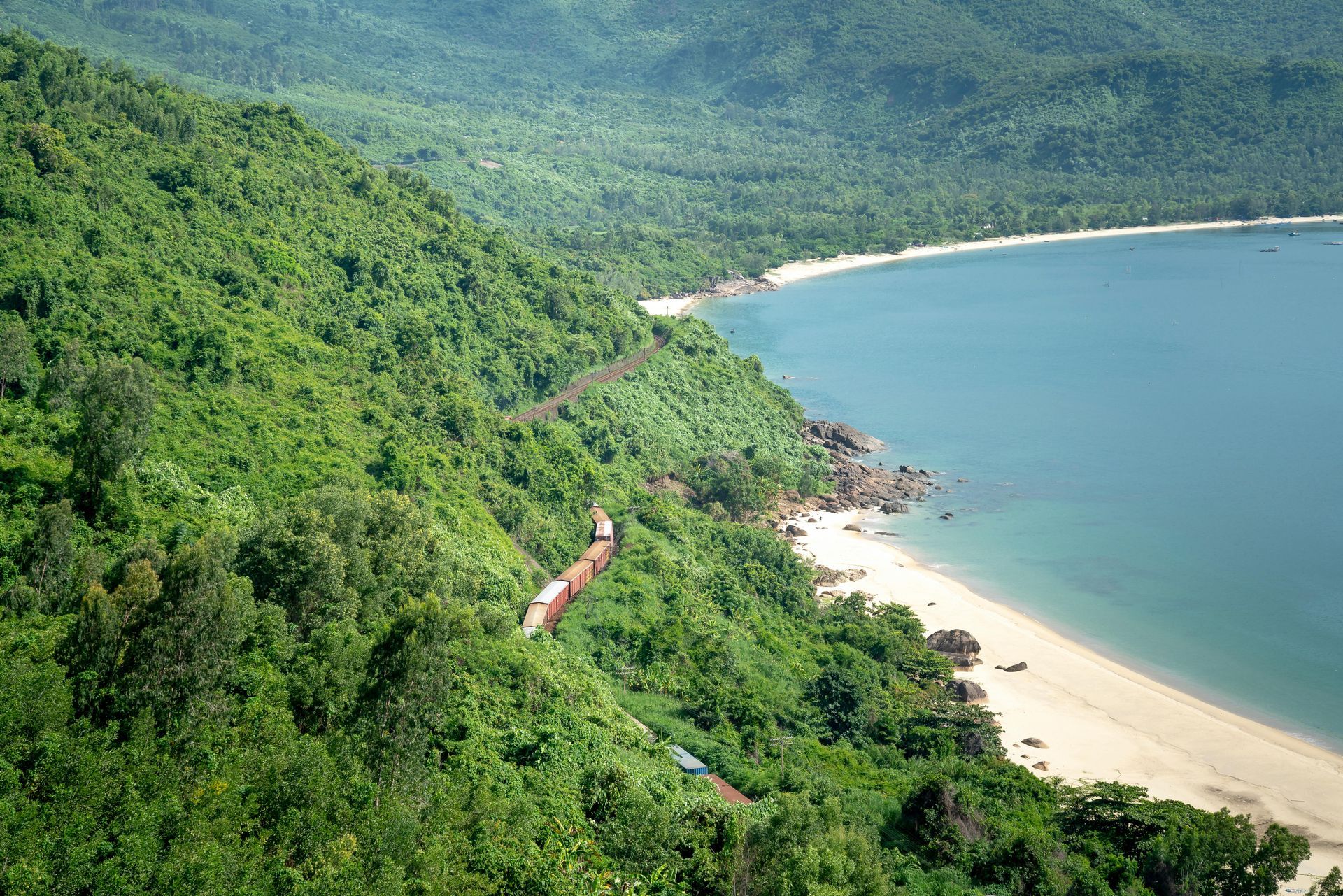 A train is going down a hill next to a beach Vietnam