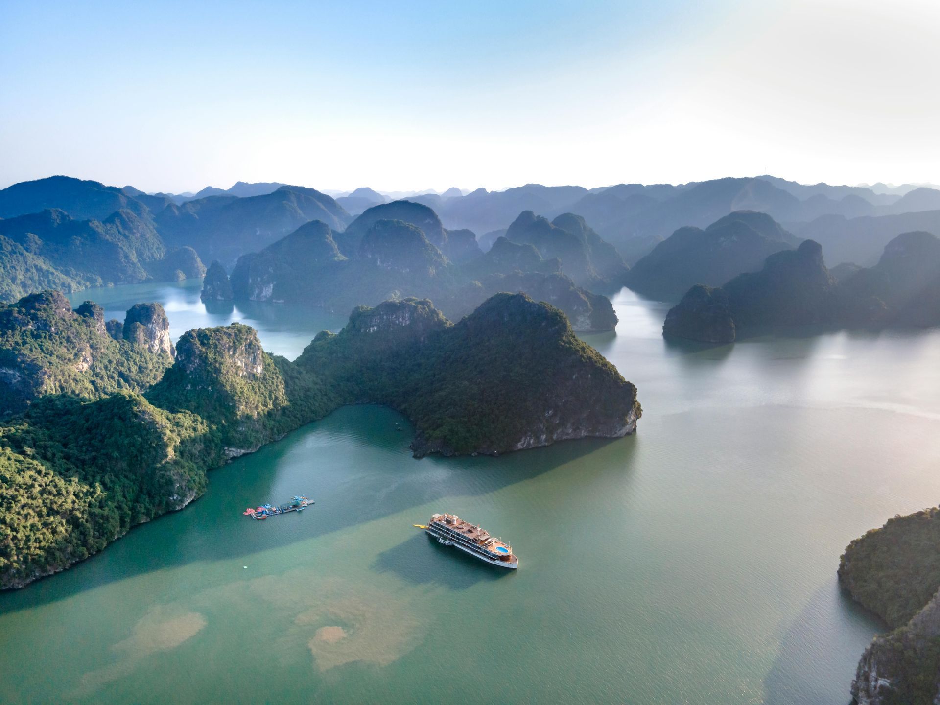An aerial view of a large body of water surrounded by mountains in Ha Long Bay.