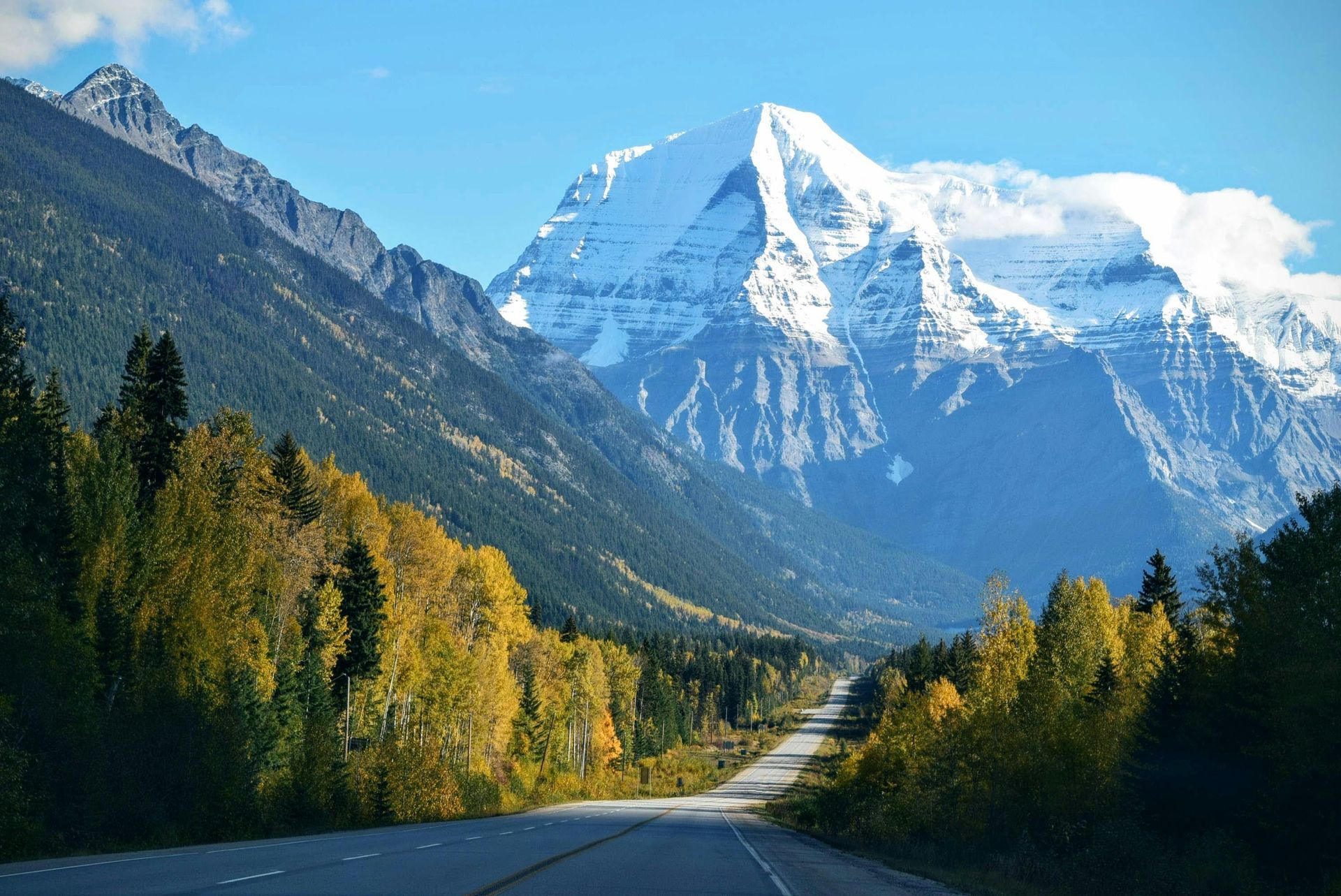 A road with a mountain in the background and trees on the side on the Trans-Canada highway