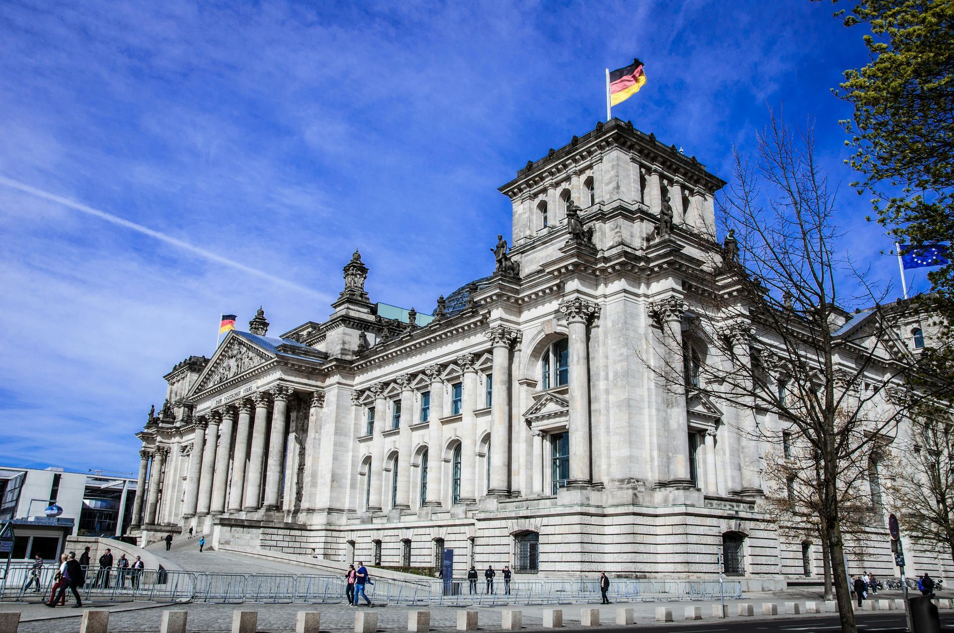 Reichstag building with a German flag on top of it.