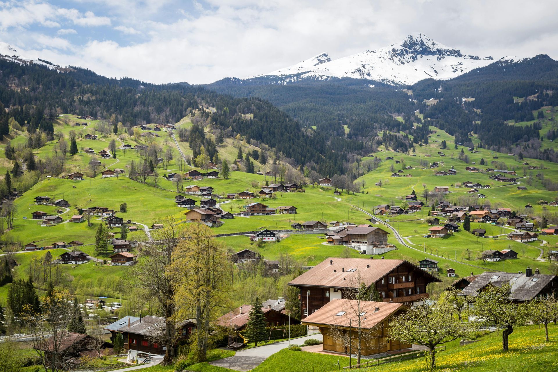 A small village in the mountains with a mountain in the background in Switzerland.