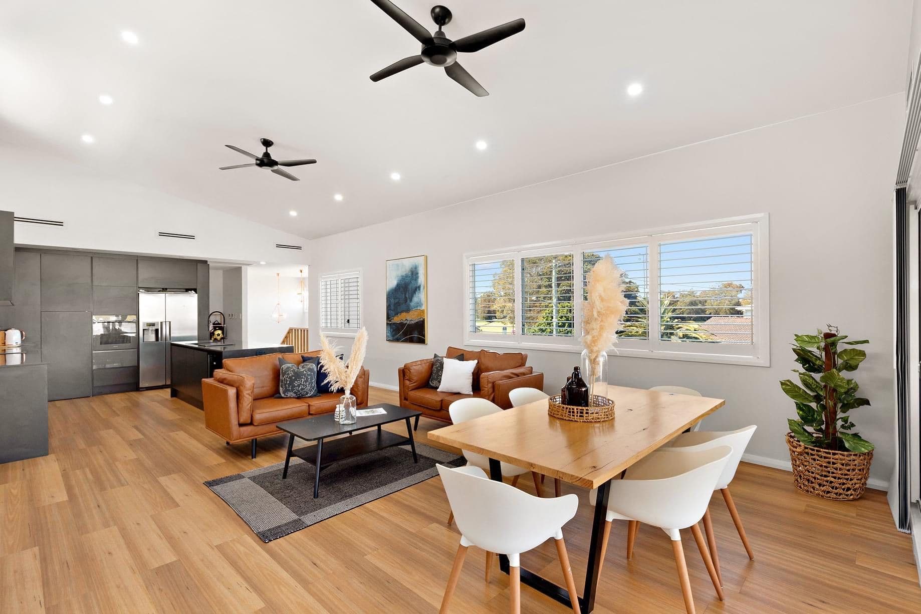 Modern Living Room With Brown Couches — Ranceas Building Services in Eleebana, NSW