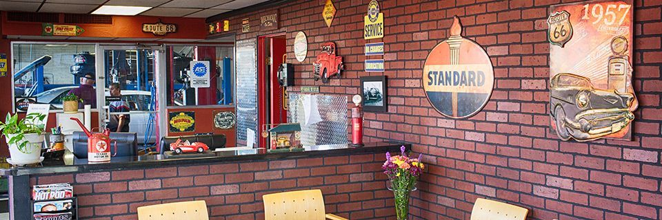 A brick wall with a sign that says ' standard ' on it | 19th Avenue Garage