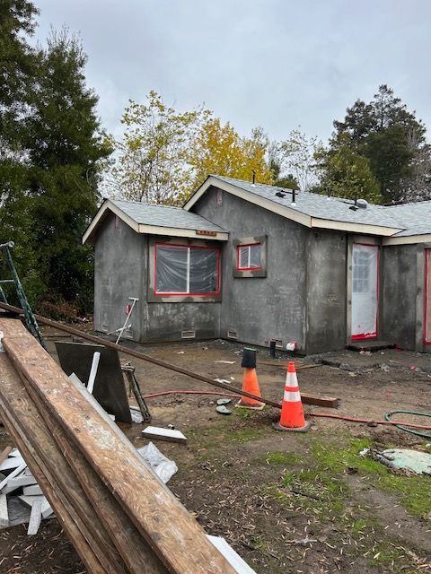 A couple of houses that are being built with cones in front of them.