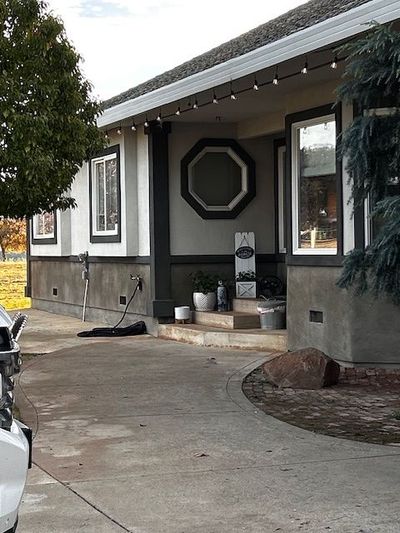 A house with a motorcycle parked in front of it