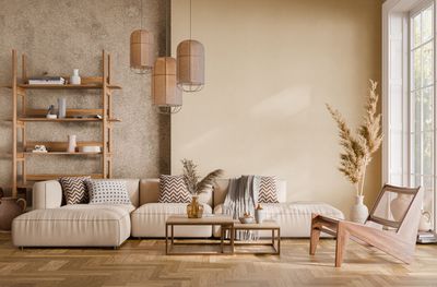 A living room with a couch , chair , coffee table and shelves.