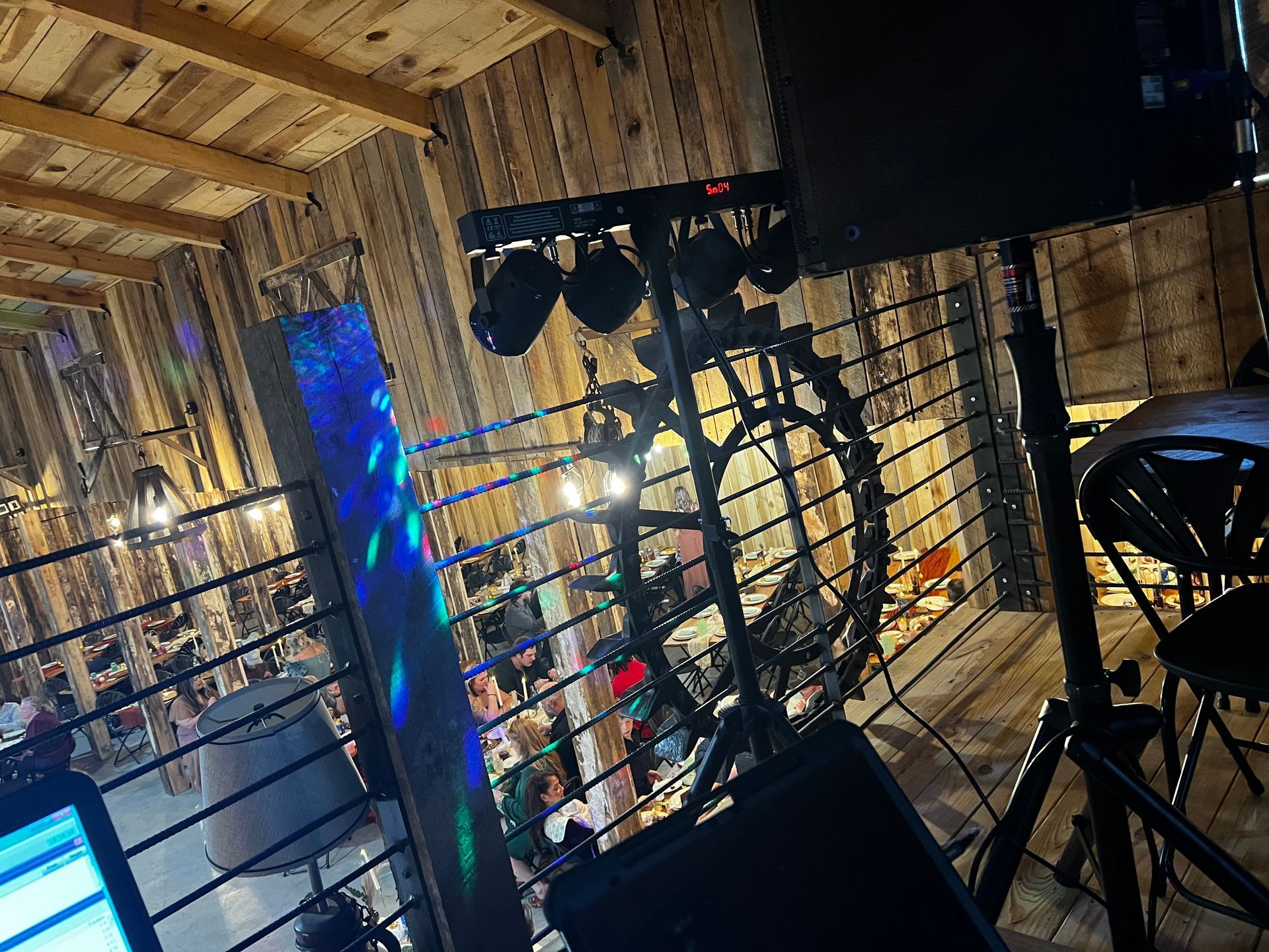 DJ setup at a rustic barn for a wedding reception, providing a vibrant atmosphere.