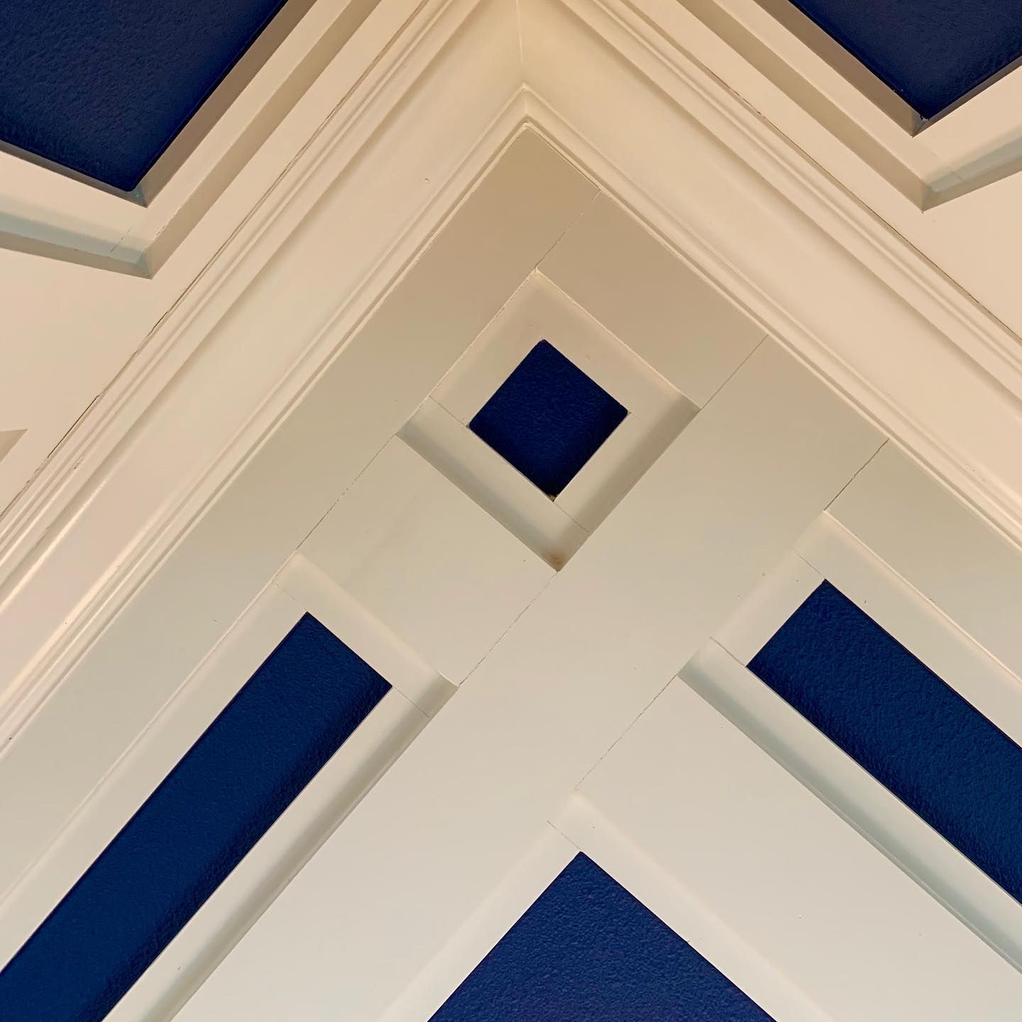 a blue and white ceiling with a square in the middle