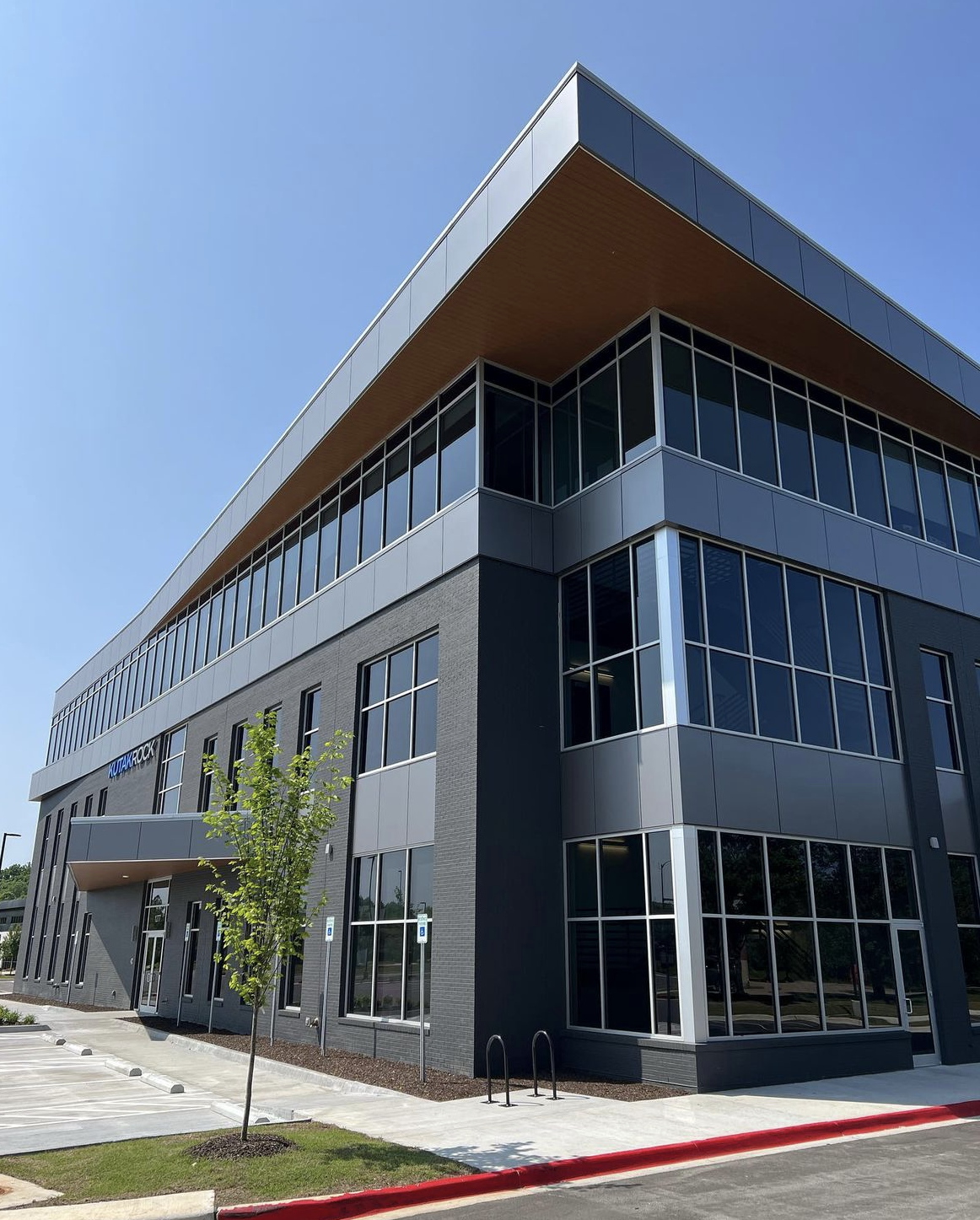 a large building with a lot of windows on a sunny day .