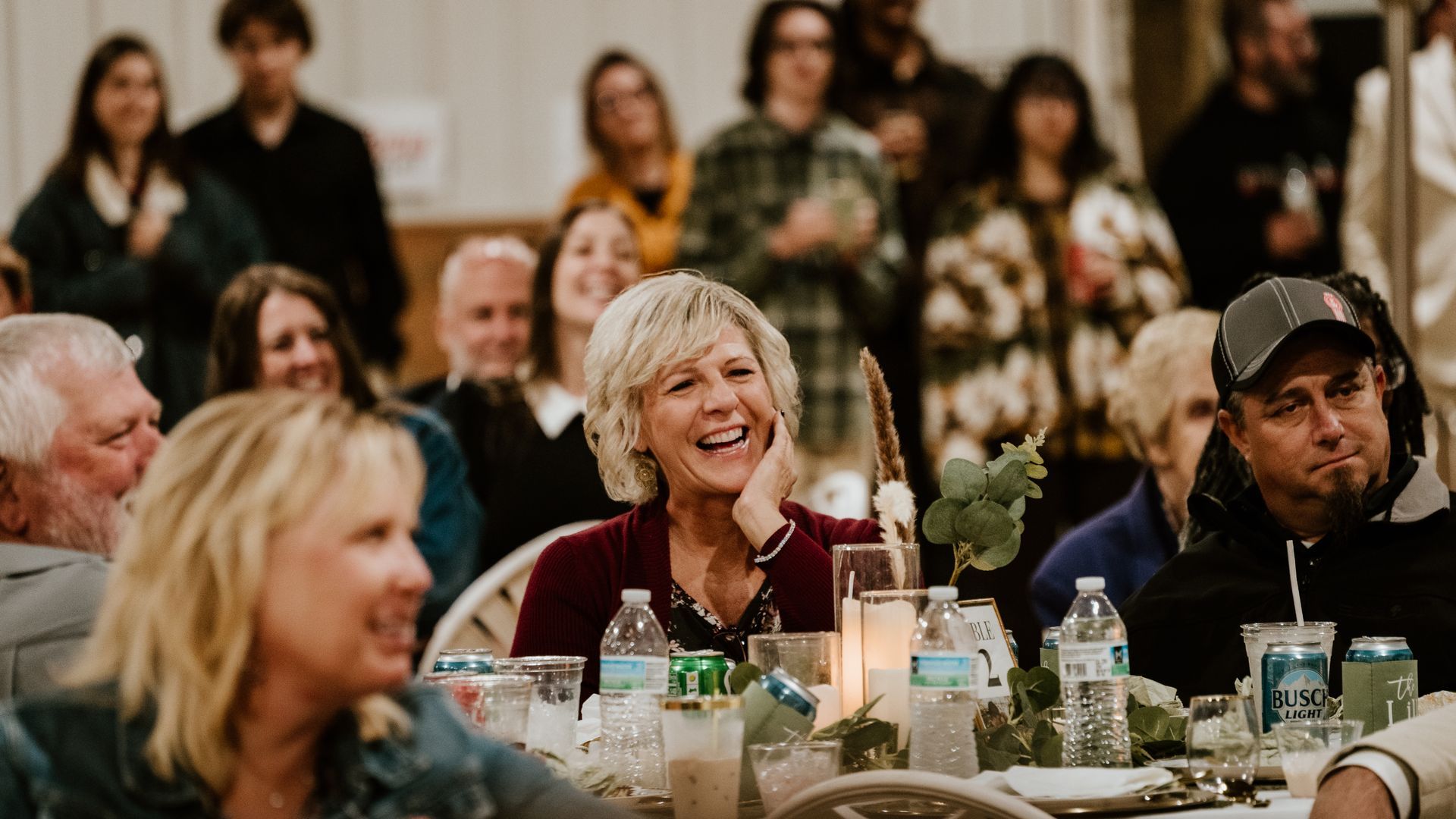 A group of people are sitting at a table laughing.