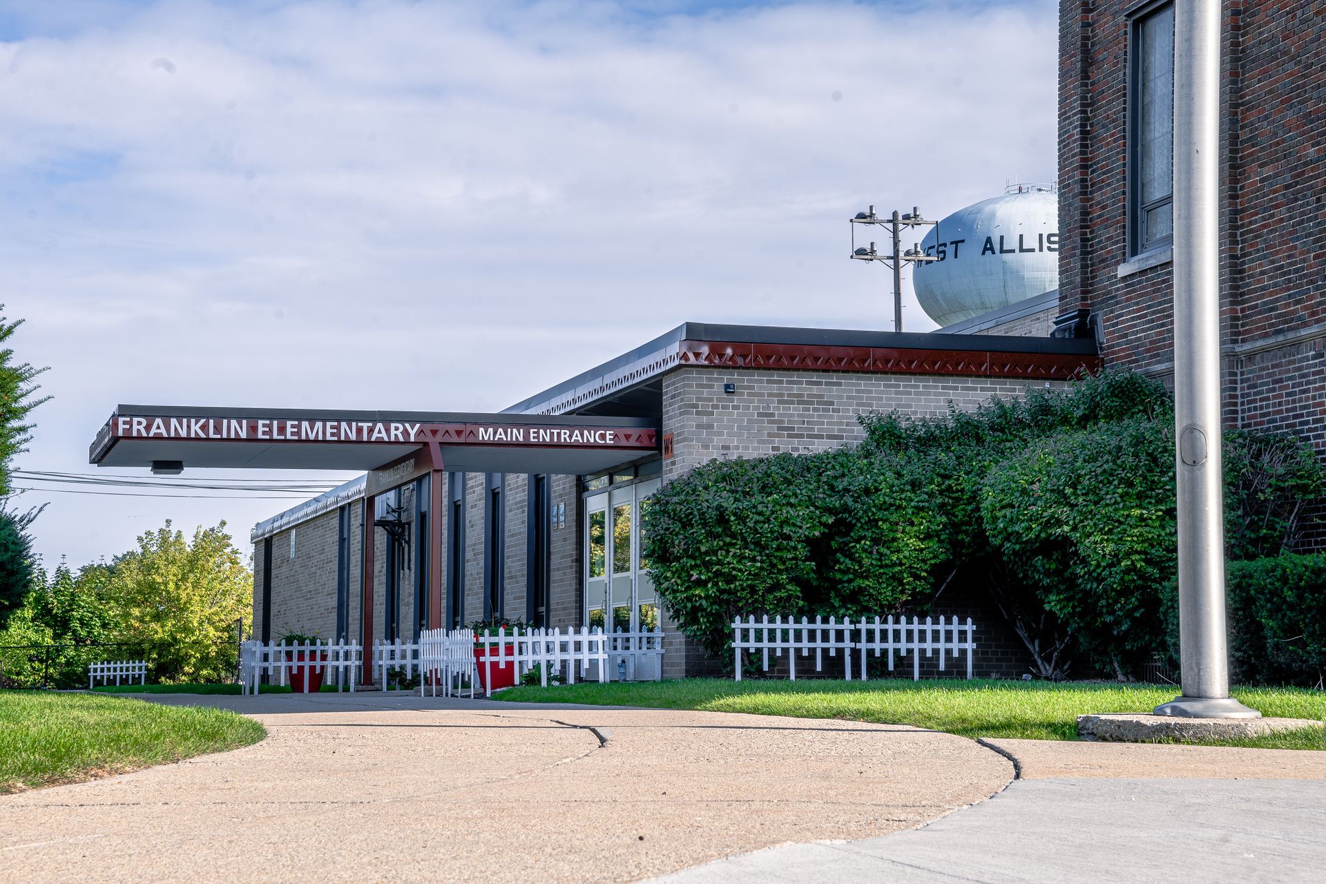 A brick building with a flag pole in front of it
