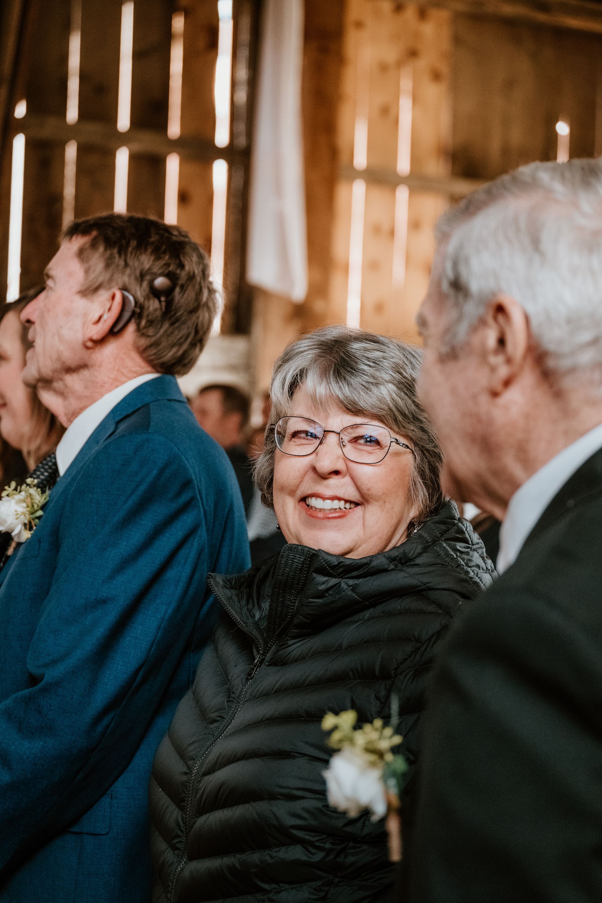 A group of people are standing in a room and smiling.