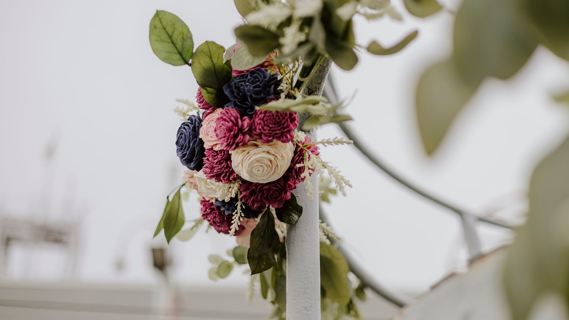 A close up of a bouquet of flowers on a pole.