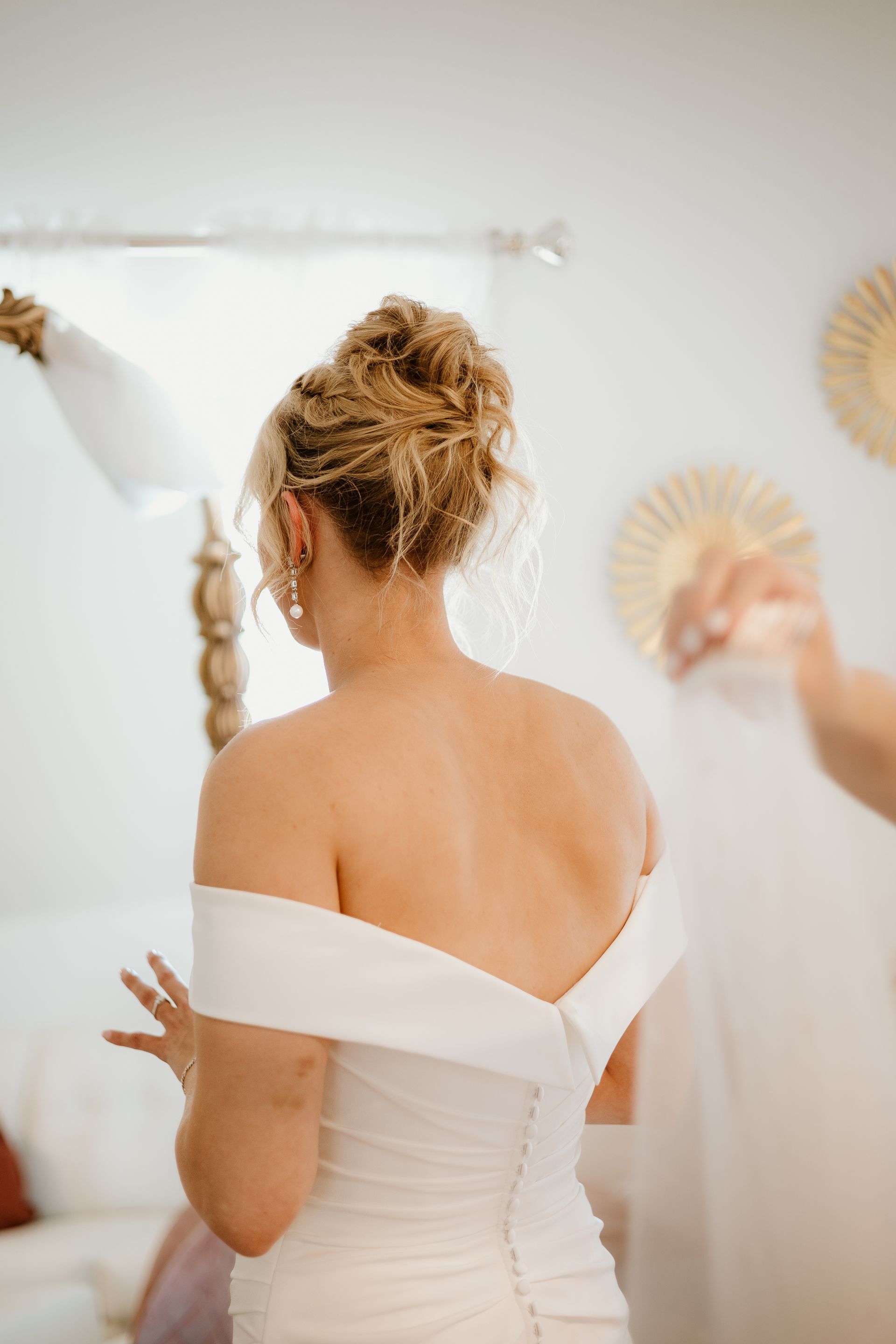 A woman in a white dress is getting ready for her wedding.