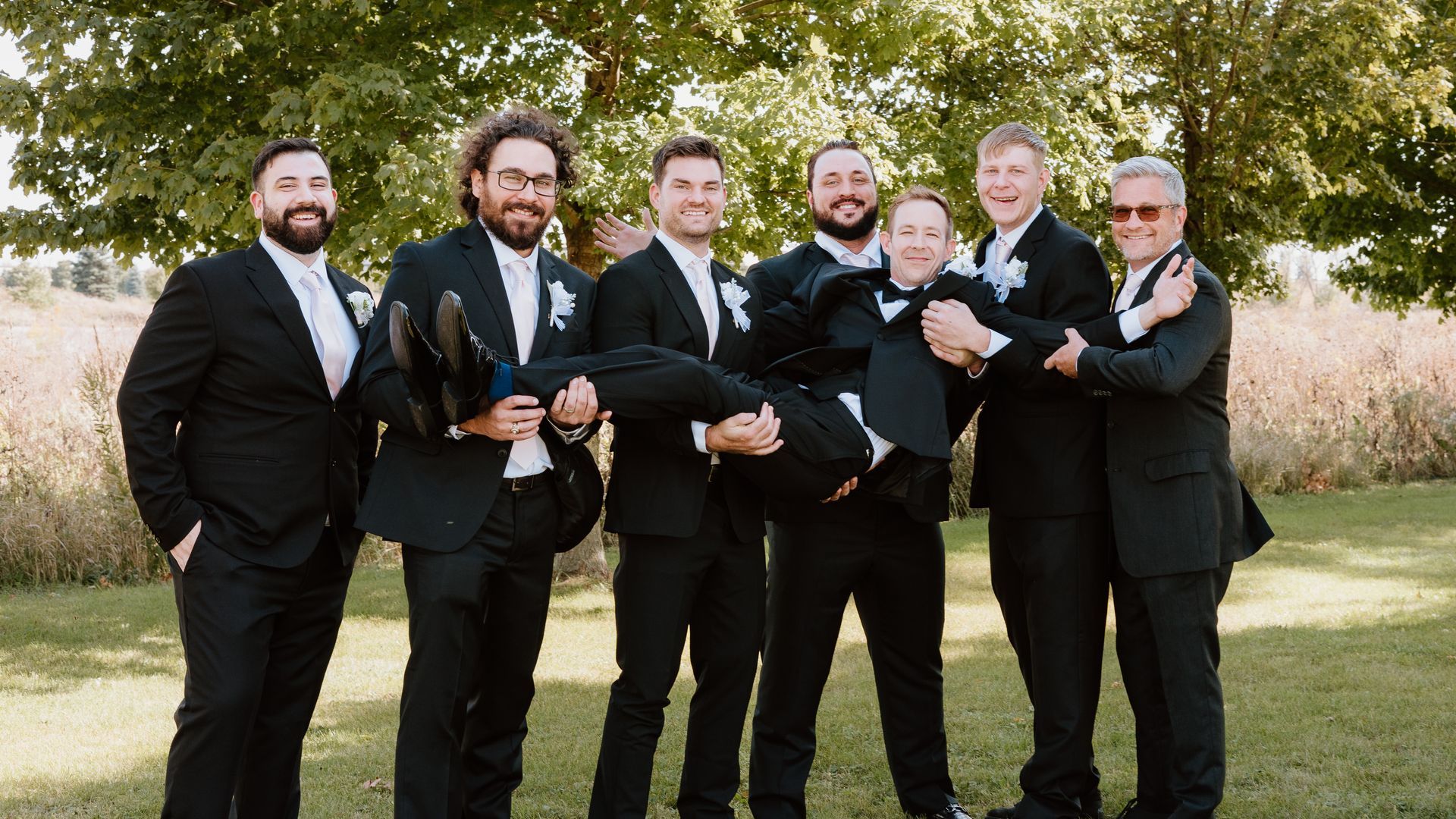 A group of men in suits are posing for a picture.